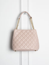 Small quilted leather bag with gold detail